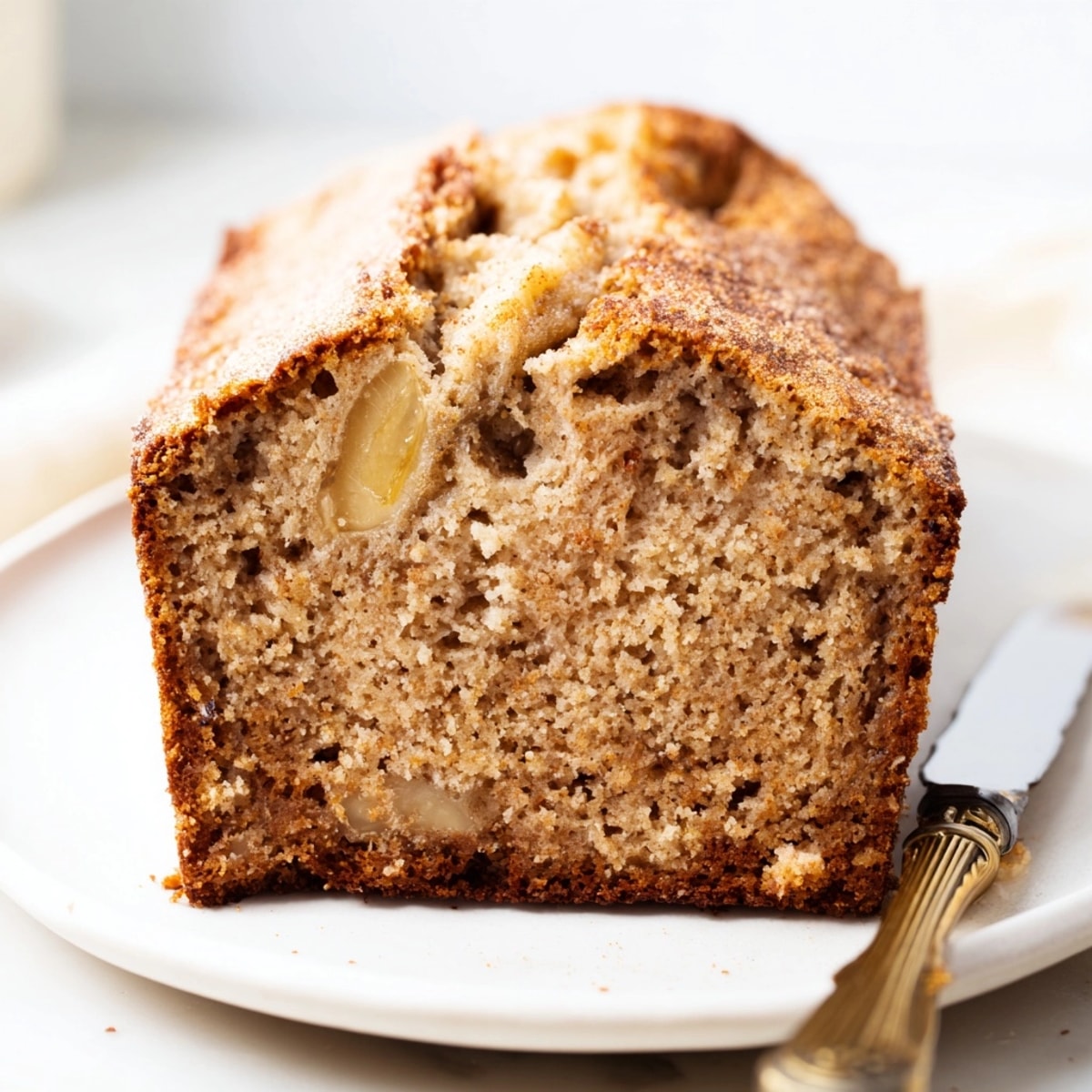 Easy banana bread recipe: see the soft, delectable crumb texture and nutty topping.
