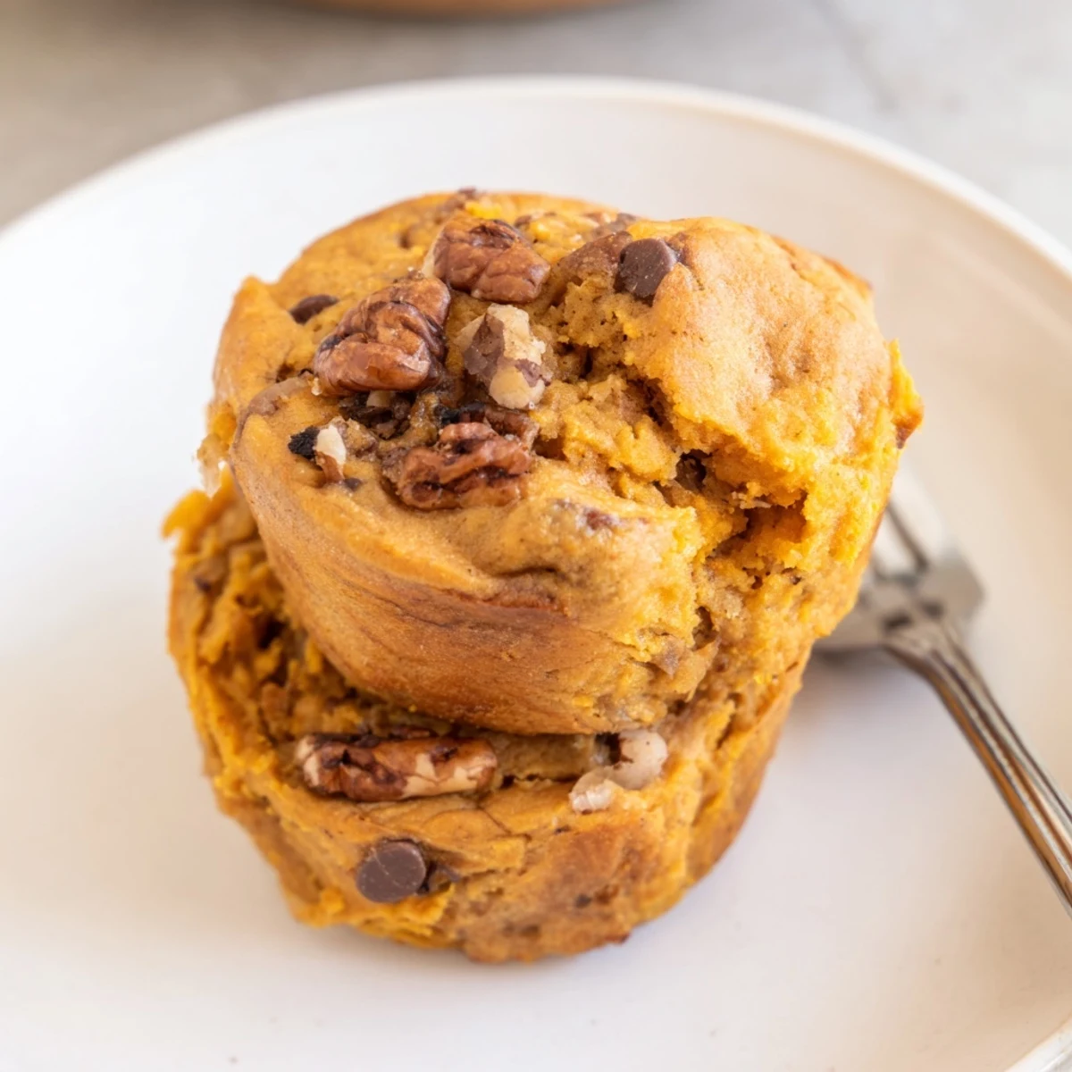 Moist Sweet Potato Pancake Drop Muffins topped with melted butter and maple syrup.  