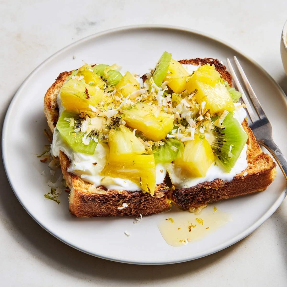 Creamy Yogurt-Custard Toast topped with fresh mango and pineapple slices.  