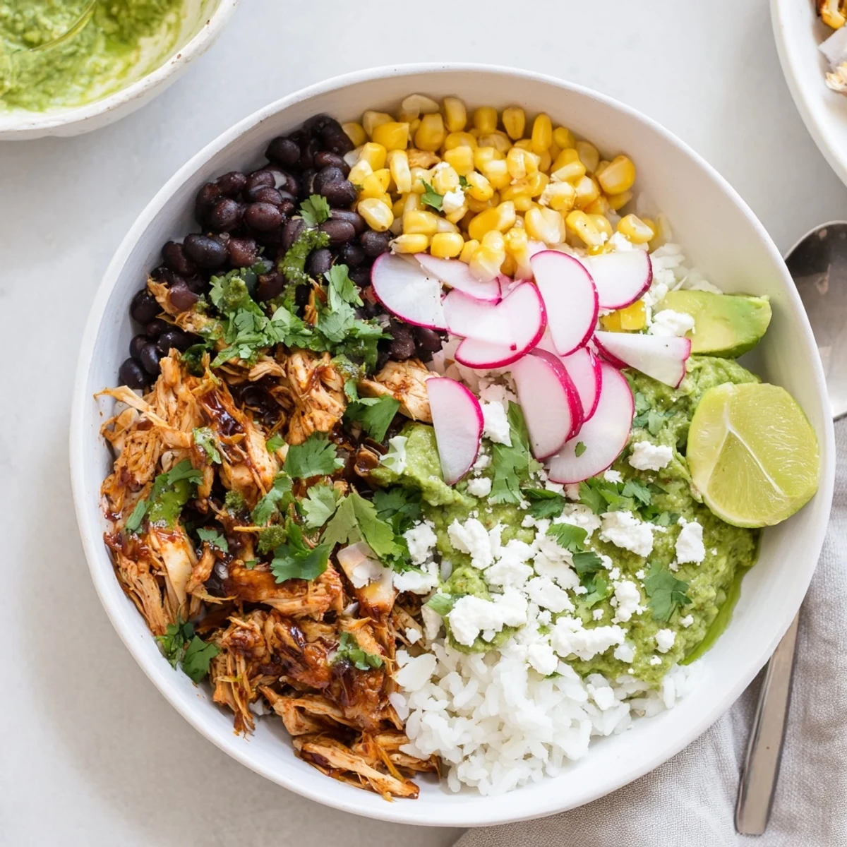 A colorful green enchiladas rice bowl topped with avocado and cheese.  