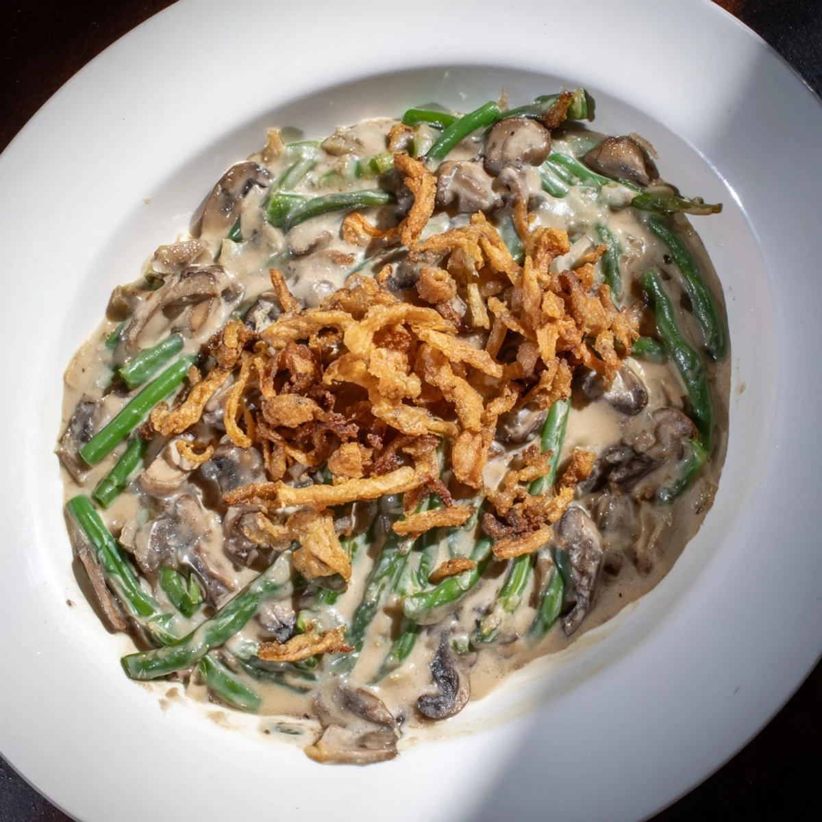 Classic Old-School Green Bean Casserole, topped with crispy onions, bubbling hot and delicious.
