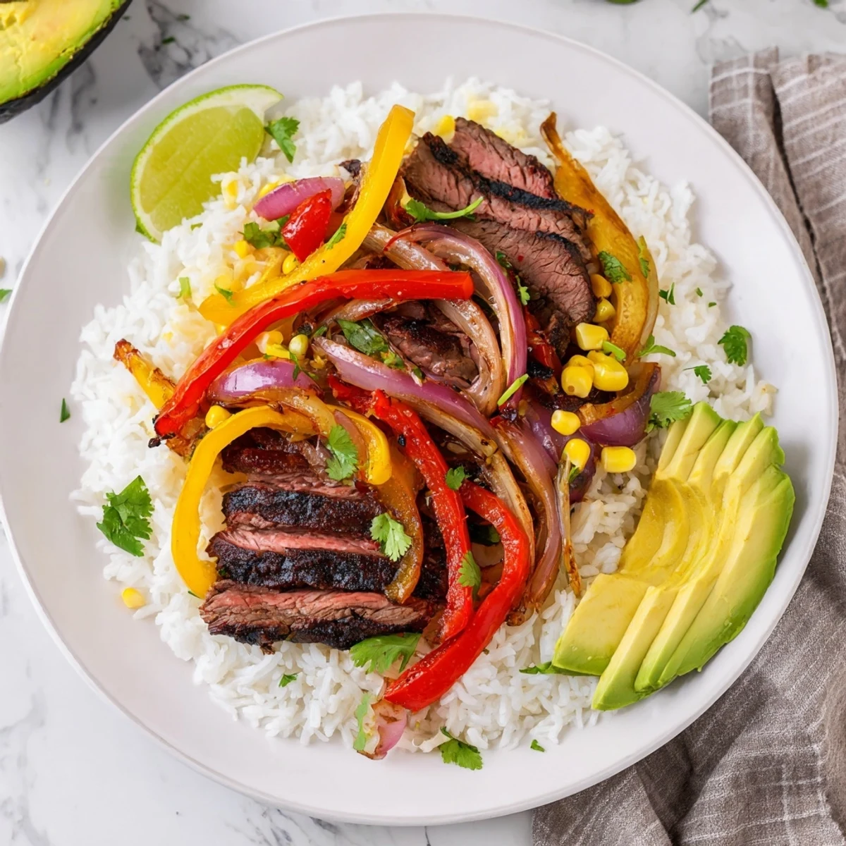 Savory BBQ Steak Fajita Bowl piled high with colorful peppers, juicy steak, and fresh avocado.
