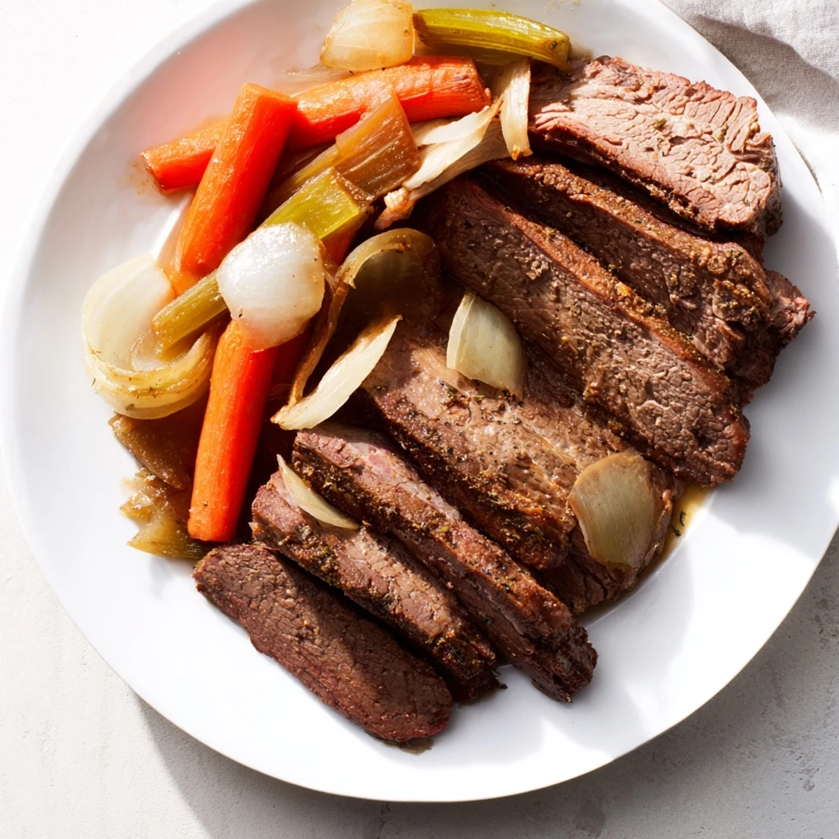 A close-up of slow-cooked classic brisket, juicy with vegetables, resting next to a sweet potato mound.