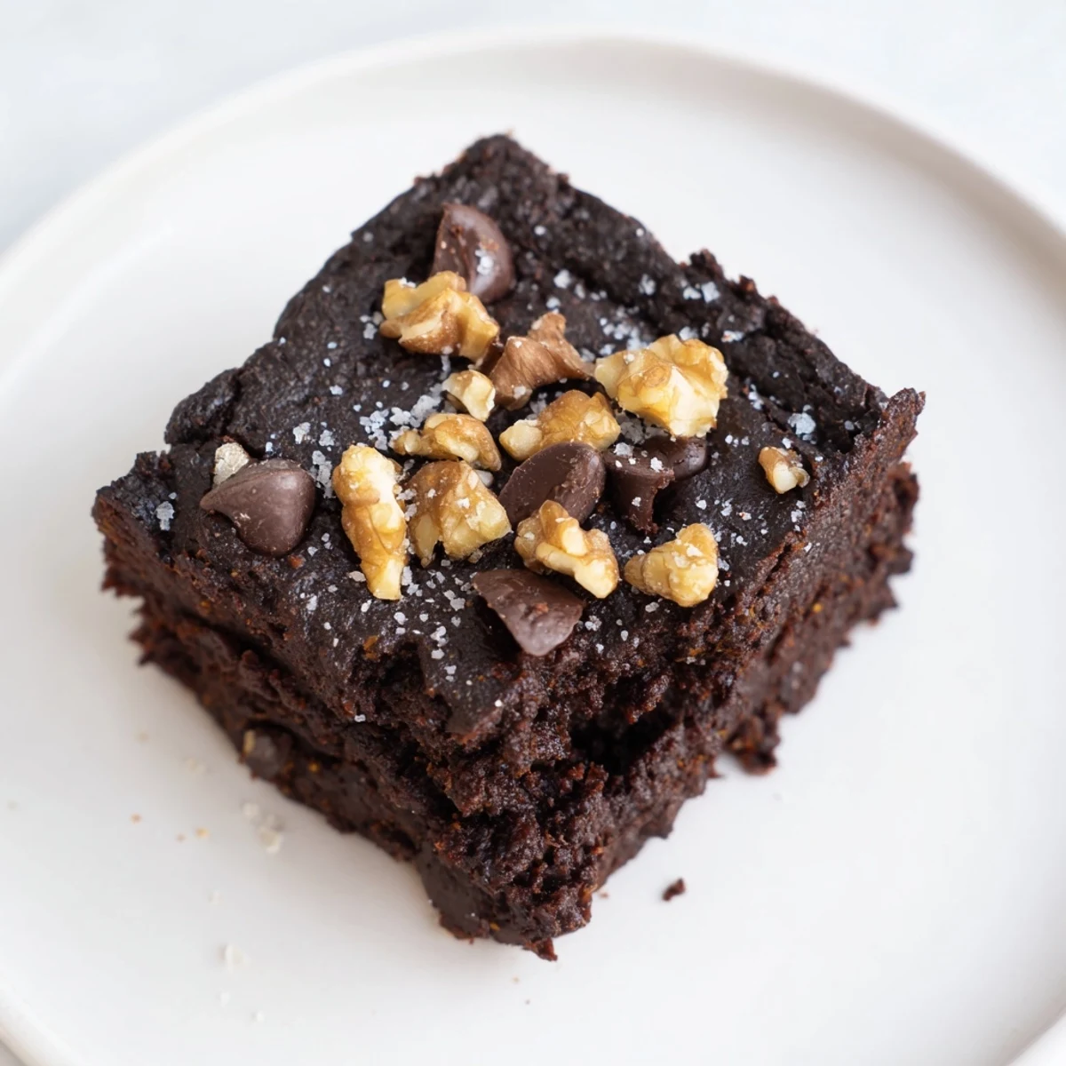 Fudgy sweet potato brownies, perfect gluten-free dessert, rich with dark chocolate chips and nuts.