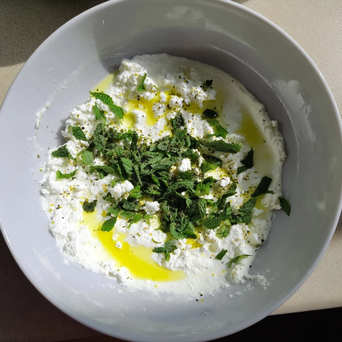 A close-up of the flavorful whipped feta dip, perfectly topped with zesty lemon-mint.