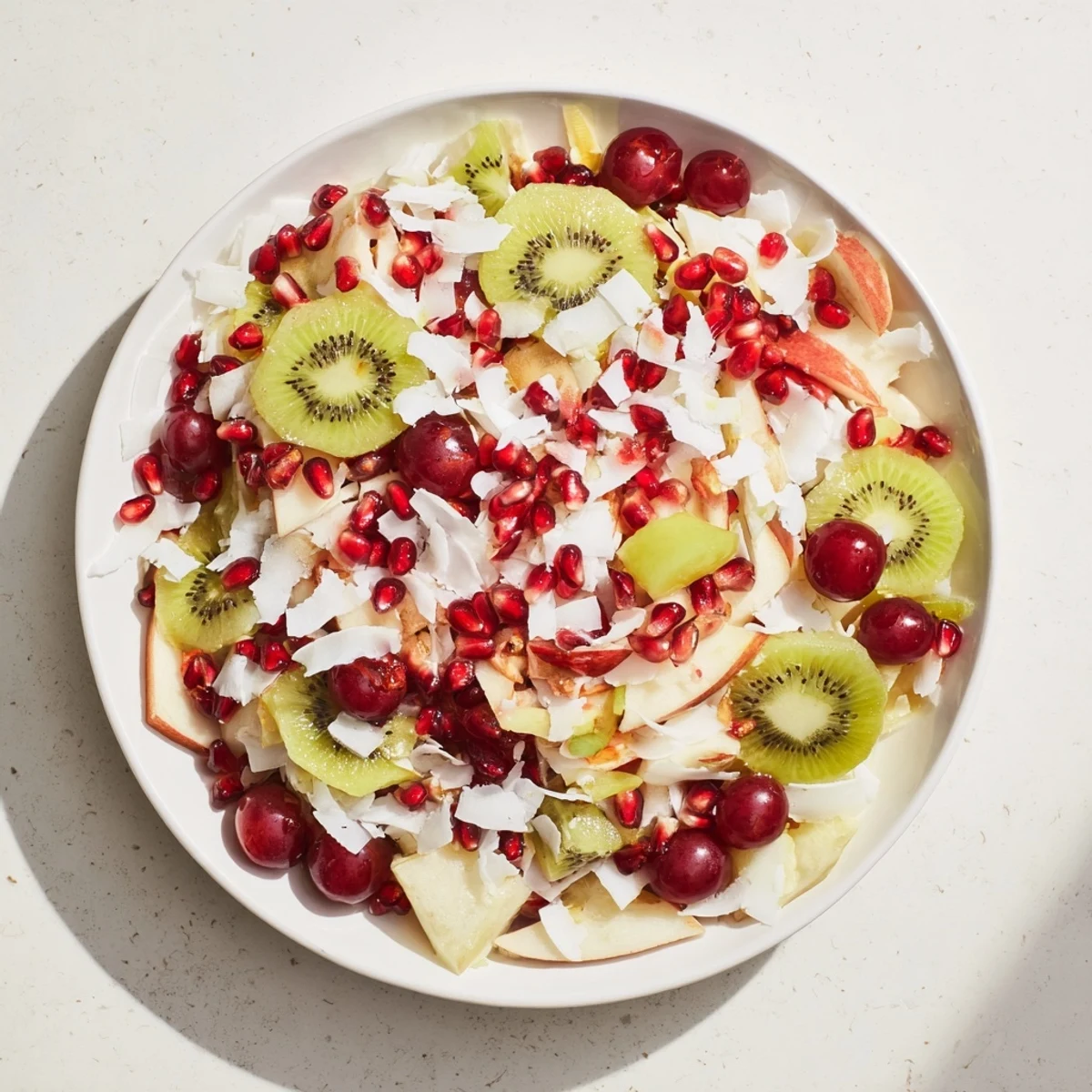 Festive Snowflake Fruit Medley with a snow-like coconut topping, perfect for any winter gathering.