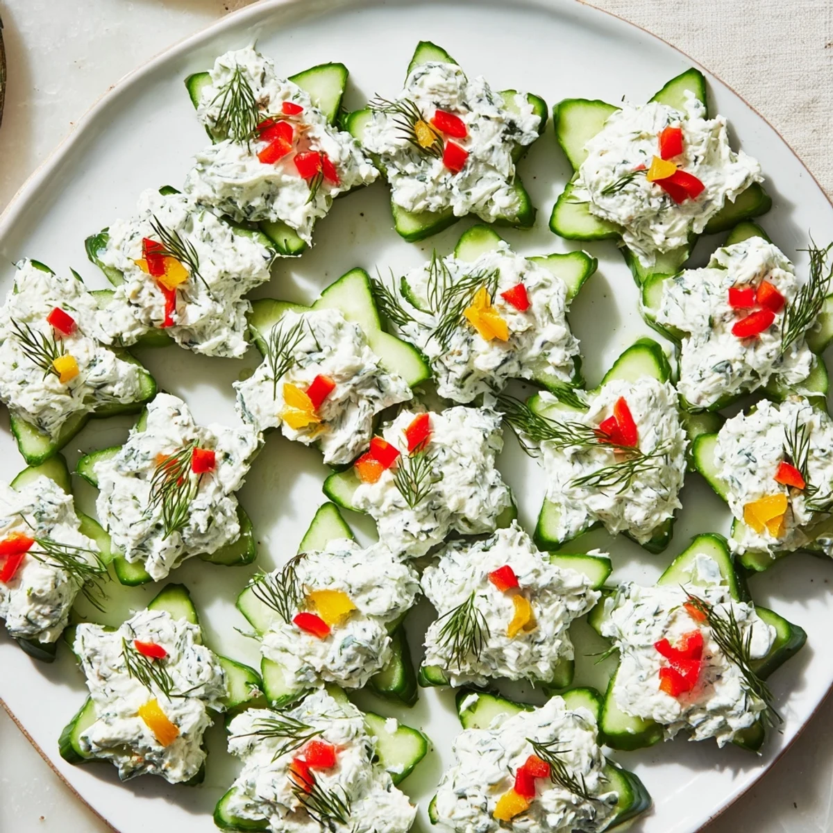 Beautiful Cucumber and Dill Christmas Stars: creamy cheese piped atop crisp cucumber, ready to serve.