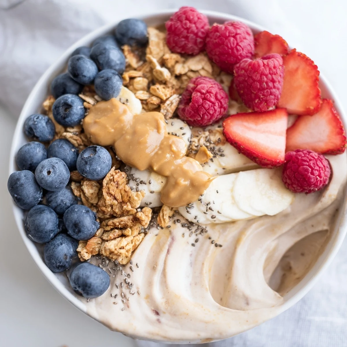 A refreshing close-up of protein ice cream bowls with a swirl of vanilla and fruit toppings.