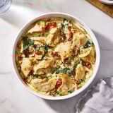 This homemade Marry Me Chicken Casserole shows juicy chicken and sun-dried tomatoes in a rich sauce.