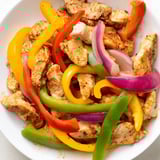 The fully cooked Sheet-Pan Chicken Fajitas, steaming hot and ready to be wrapped in tortillas.