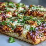 Smoky grilled BBQ chicken flatbread pizza loaded with cheese, fresh cilantro, and jalapeño for bold flavor.  
