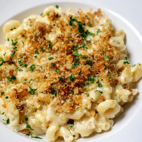 A bubbly, golden Tinis Mac and Cheese with Bacon, promising a rich, cheesy, savory flavor experience.
