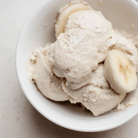 Creamy 2-Ingredient Banana Ice Cream swirls in a bowl, a healthy and delightful dessert.
