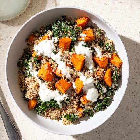 Savory roasted sweet potato quinoa bowl recipe with tender kale, ready for a healthy lunch.
