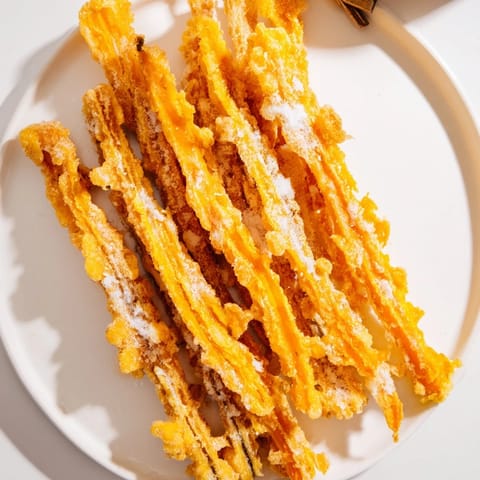 Deliciously golden tempura pumpkin fries served hot with a tangy dipping sauce.  