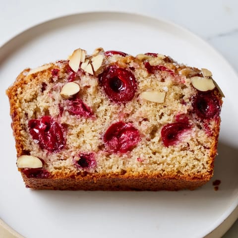 Warm, freshly baked Cherry Almond Loaf Cake; imagine the sweet almond scent and moist texture.