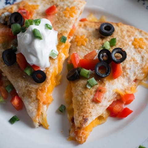 Enjoy these easy Express Snowflake Quesadillas, a delightful, visually appealing snack, served with cool sour cream.