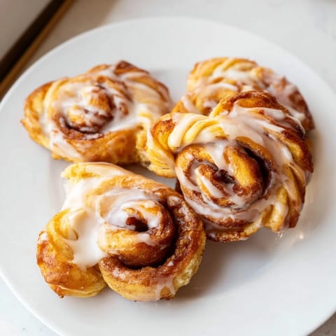 Easy homemade air-fryer cinnamon roll twists, showing layers of cinnamon-sugar filling and a light, crispy crust.