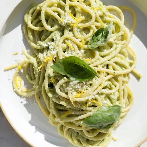 Close-up of freshly prepared creamy avocado pasta, perfect for a quick, delicious vegetarian meal.