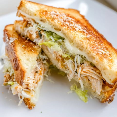 Buffalo Chicken Caesar Grilled Cheese with creamy dressing and crisp romaine on buttery grilled bread.  