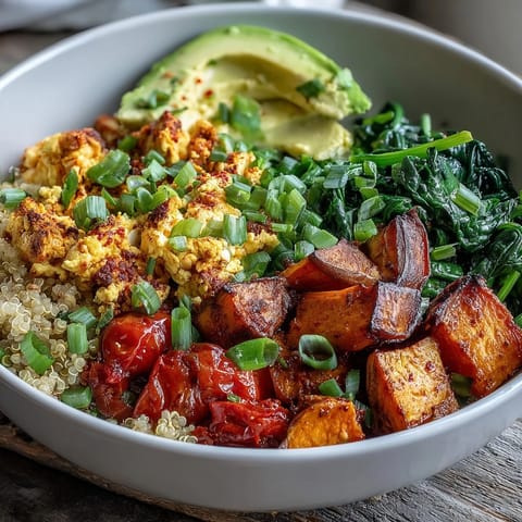 Tofu Scramble Vegan Breakfast Bowl with fluffy quinoa, roasted sweet potatoes, and creamy avocado slices.