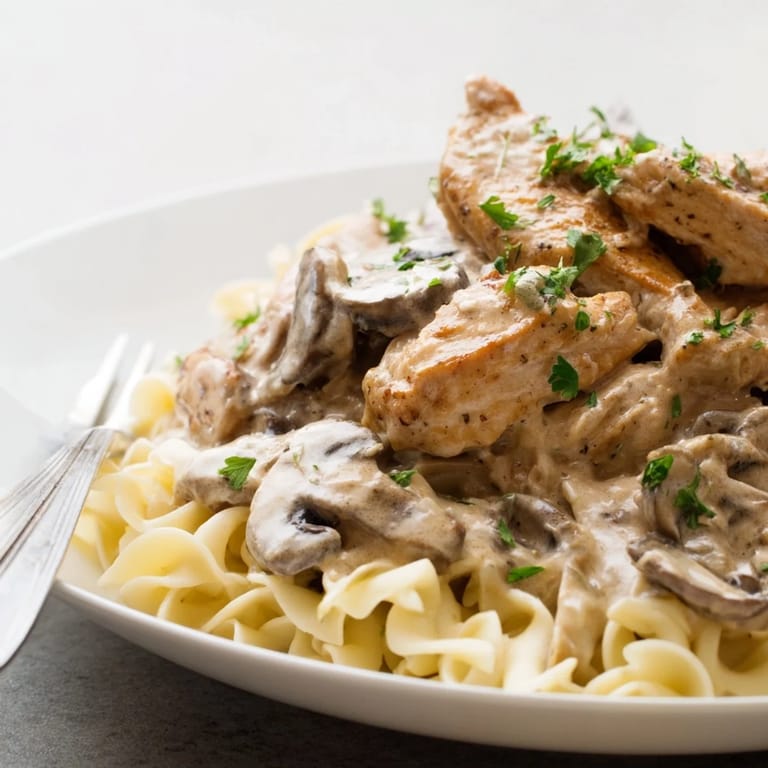 A mouthwatering bowl of Creamy Chicken Stroganoff, featuring succulent chicken and savory mushrooms.  