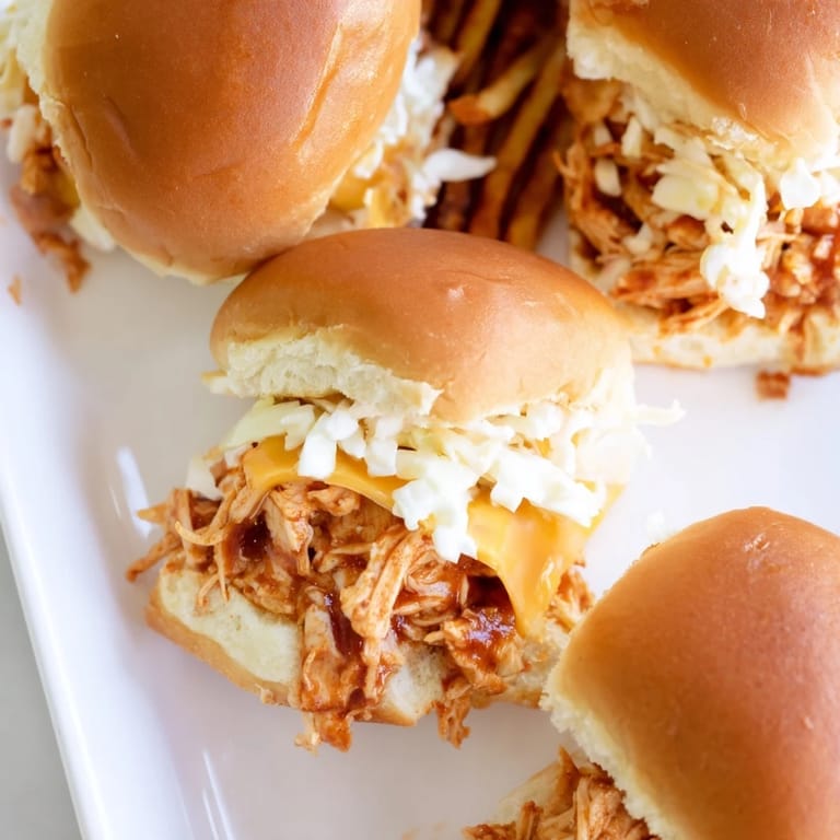 Decadent BBQ Chicken Sliders with golden fries, perfect for game day gatherings.