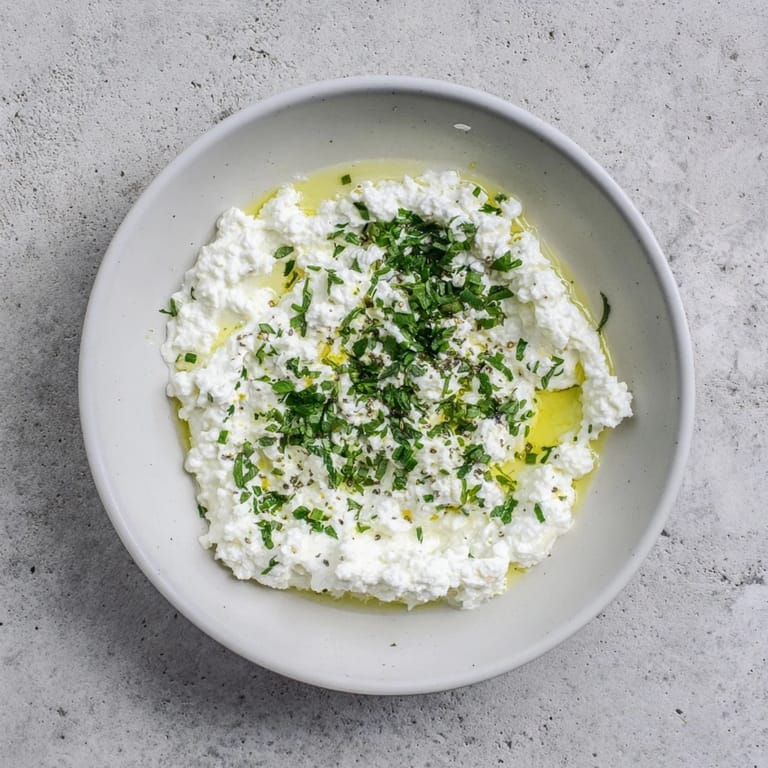 Delightful Mediterranean appetizer: A bowl of whipped feta, drizzled with lemon-mint and ready to serve.