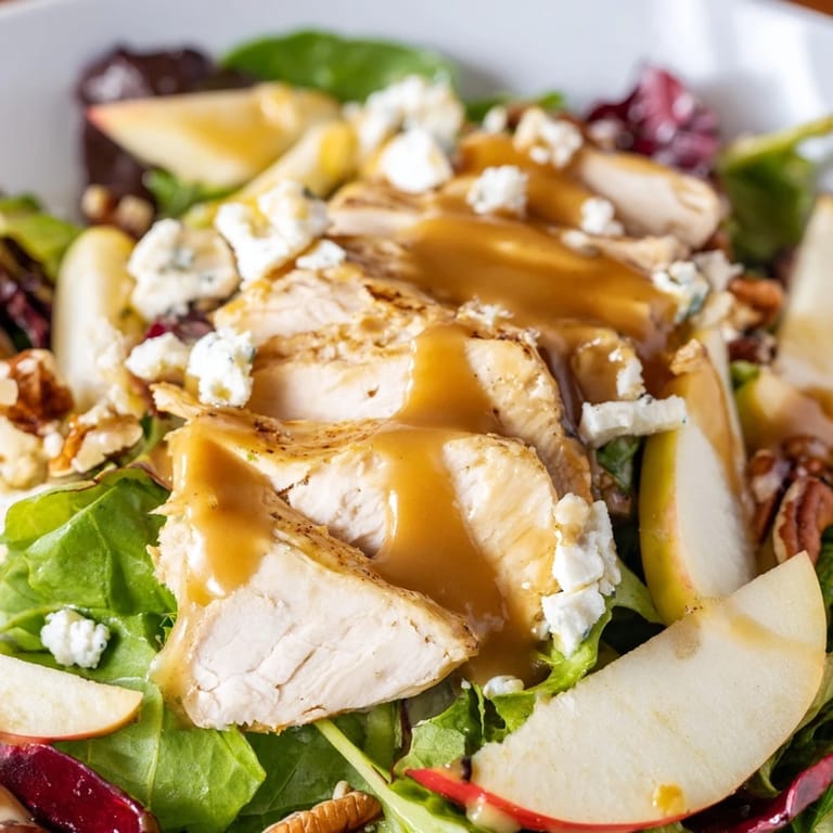 Platter of fresh caramel apple chicken salad with dried cranberries, red onion, and candied pecans.