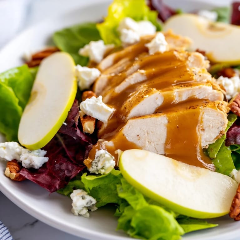 Golden caramel-pecan dressing drizzled over autumn chicken salad with crisp apples and crumbled feta.  